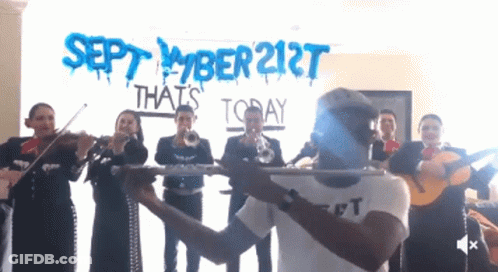 A Group Of Mariachi Players Playing In Front Of A Sign That Says September 21St That 'S Today GIF