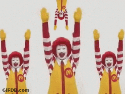 A Group Of Mcdonald 'S Mascots Are Holding Their Arms Up In The Air . GIF