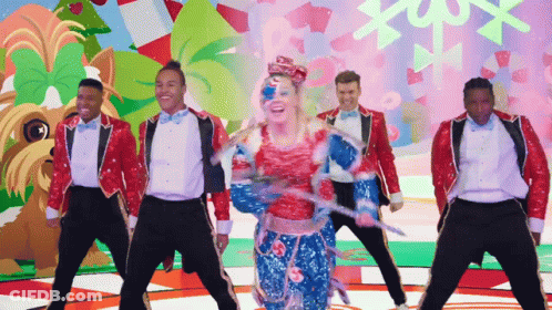 A Group Of Men And A Woman Are Dancing In Front Of A Colorful Background GIF