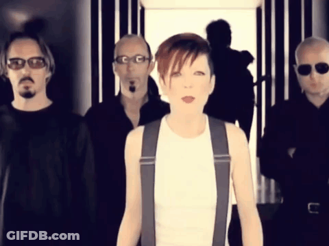 A Group Of Men And A Woman Are Standing In A Line GIF