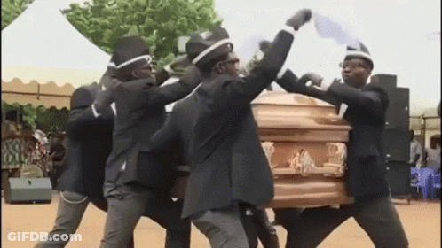 A Group Of Men Are Carrying A Coffin And Dancing Around It . GIF