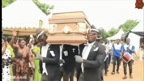 A Group Of Men Are Carrying A Coffin In A Funeral Procession GIF