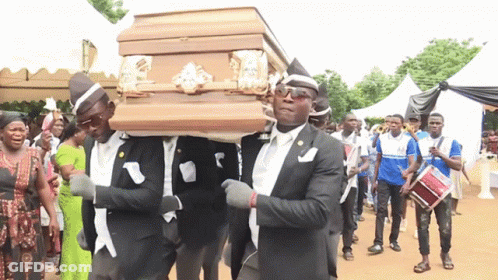 A Group Of Men Are Carrying A Coffin In A Line GIF