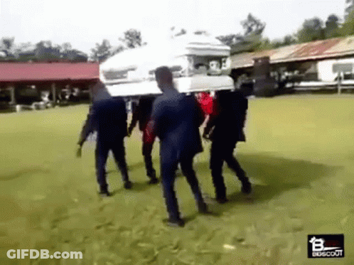 A Group Of Men Are Carrying A Coffin On Their Backs . GIF
