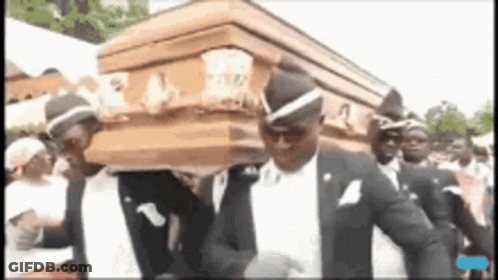 A Group Of Men Are Carrying A Coffin While Dancing . GIF