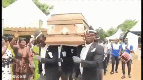 A Group Of Men Are Carrying A Coffin While Dancing . GIF