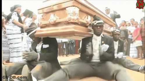 A Group Of Men Are Carrying A Wooden Coffin With A Sign That Says ' R.i.p ' On It GIF