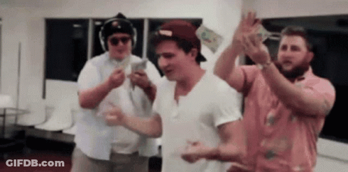A Group Of Men Are Dancing And Holding Up Money . GIF