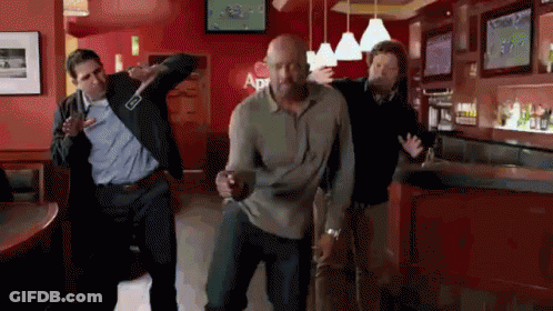 A Group Of Men Are Dancing In A Bar With A Sign That Says Apr On It GIF
