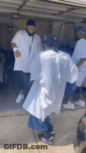 A Group Of Men Are Dancing In A Garage With One Wearing A Hat That Says ' Ny Yankees ' On It GIF