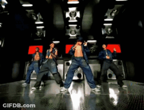 A Group Of Men Are Dancing In A Room With A Lot Of Speakers GIF