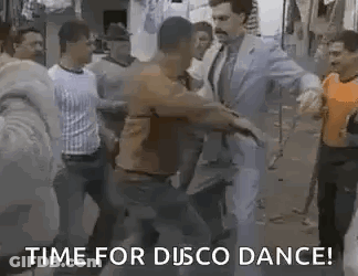 A Group Of Men Are Dancing In A Street With A Man In A Suit And Tie . GIF