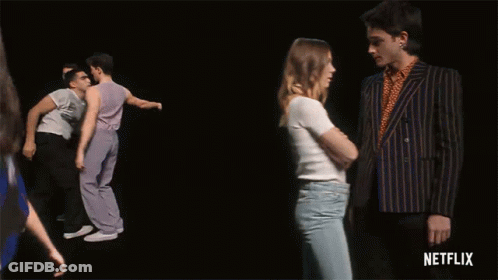 A Group Of Men Are Dancing In Front Of A Black Background With Netflix Written On The Bottom GIF