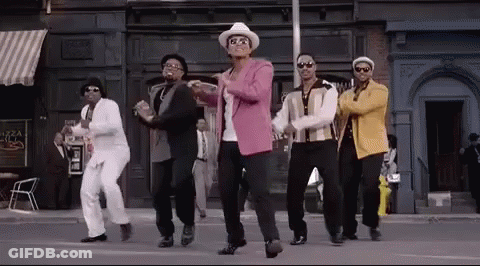 A Group Of Men Are Dancing In Front Of A Building . GIF