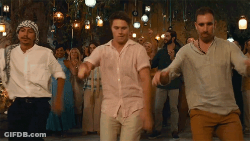 A Group Of Men Are Dancing In Front Of A Crowd Of People At A Party . GIF