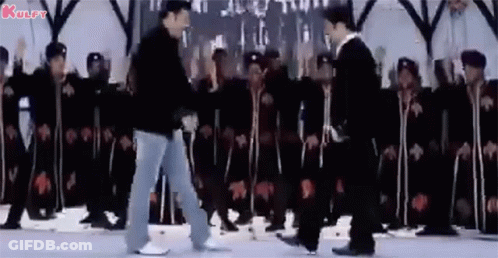 A Group Of Men Are Dancing In Front Of A Crowd Of People . GIF