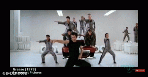 A Group Of Men Are Dancing In Front Of A Red Car And The Words Grease ( 1978 ) Paramount Pictures GIF