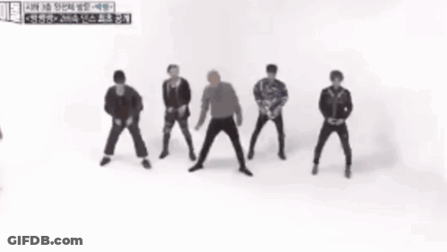 A Group Of Men Are Dancing In Front Of A Sign That Says ' 2 ' GIF