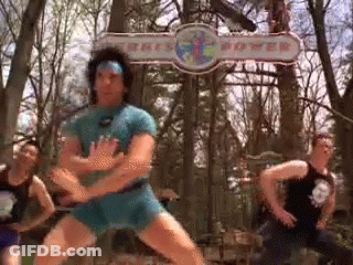 A Group Of Men Are Dancing In Front Of A Sign That Says ' Kings Power ' GIF