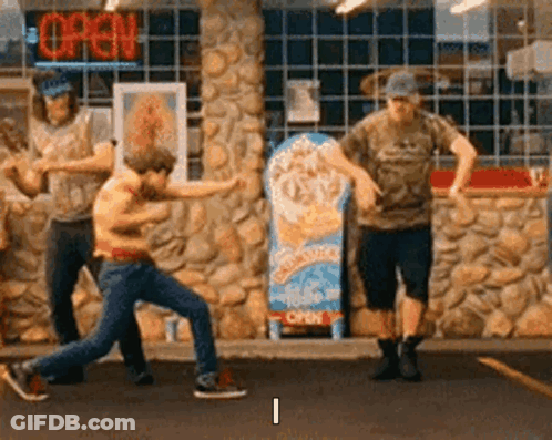A Group Of Men Are Dancing In Front Of A Store With An Open Sign . GIF