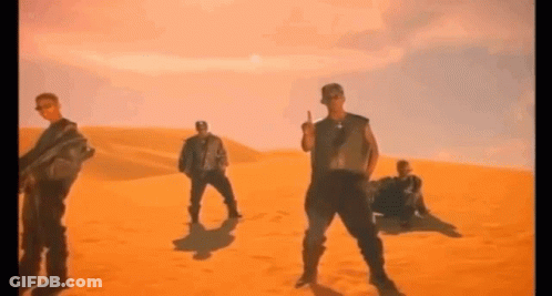 A Group Of Men Are Dancing In The Desert . GIF
