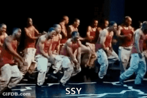 A Group Of Men Are Dancing On A Stage With The Words Ssy Written On The Bottom Of The Image . GIF
