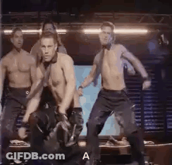 A Group Of Men Are Dancing On A Stage Without Shirts On . GIF