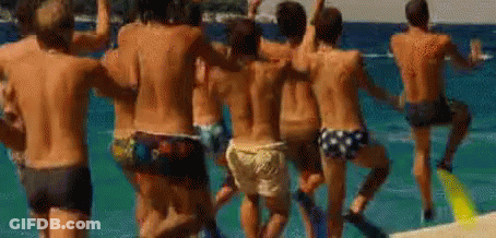 A Group Of Men Are Dancing On The Beach . GIF