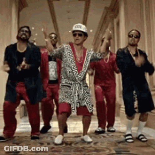 A Group Of Men Are Dancing Together In A Hallway . One Of The Men Is Wearing A Bathrobe . GIF