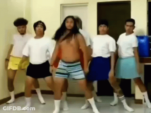 A Group Of Men Are Dancing Together In A Room While Wearing Shorts And Socks . GIF