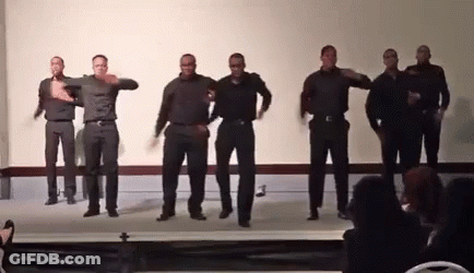 A Group Of Men Are Dancing Together On A Stage GIF