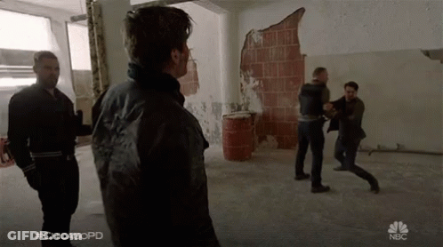 A Group Of Men Are Fighting In A Room With The Hashtag #Chicagopd On The Bottom GIF