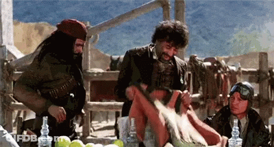 A Group Of Men Are Gathered Around A Table With Bottles Of Alcohol GIF
