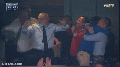 A Group Of Men Are Hugging Each Other In A Fox NFL Game GIF