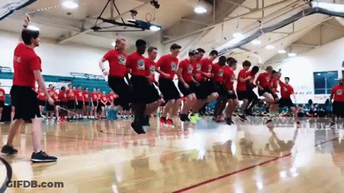 A Group Of Men Are Jumping Rope In A Gym . GIF