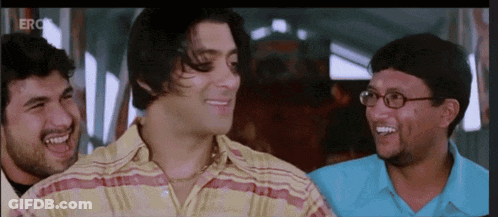 A Group Of Men Are Laughing And One Has Glasses GIF