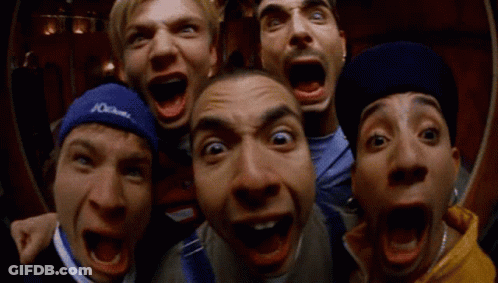 A Group Of Men Are Making Funny Faces With One Wearing A Blue Headband That Says Columbia GIF