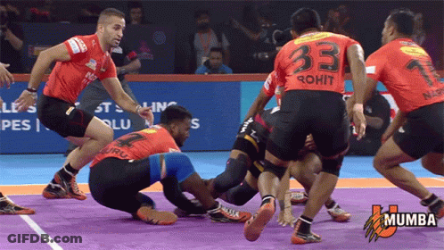 A Group Of Men Are Playing A Game Of Kabaddi And One Of Them Has The Number 33 On His Back GIF
