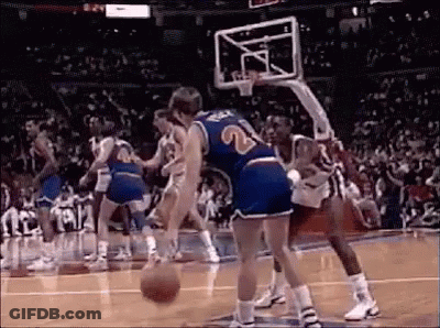 A Group Of Men Are Playing Basketball On A Court . GIF