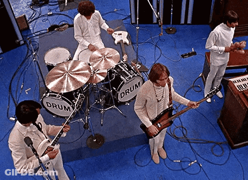 A Group Of Men Are Playing Instruments In Front Of A Drum Set That Says Drum On It GIF