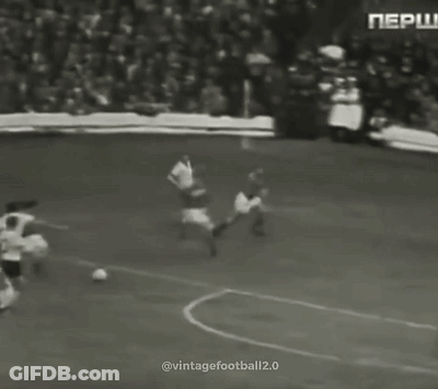 A Group Of Men Are Playing Soccer On A Field . GIF