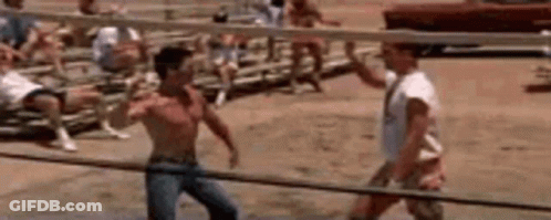 A Group Of Men Are Playing Volleyball On A Beach With A Volleyball Net In The Background . GIF