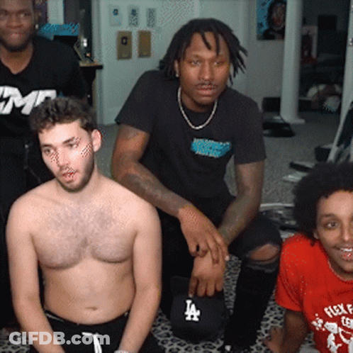A Group Of Men Are Posing For A Picture And One Of Them Has A La Hat On GIF
