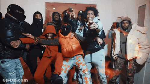 A Group Of Men Are Posing For A Picture And One Of Them Has A Ny On His Hat GIF