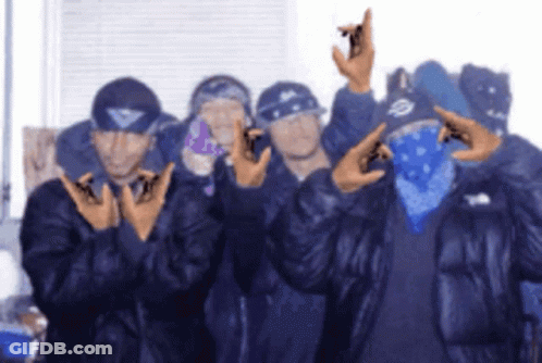 A Group Of Men Are Posing For A Picture And One Of Them Is Wearing A Bandana GIF
