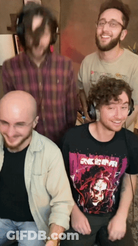 A Group Of Men Are Posing For A Picture And One Of Them Is Wearing A Shirt That Says " Akira " On It GIF