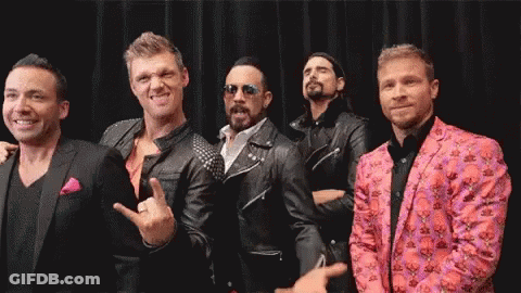 A Group Of Men Are Posing For A Picture Together . GIF