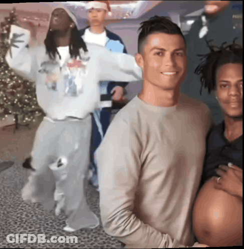 A Group Of Men Are Posing For A Picture With A Pregnant Woman In The Middle GIF