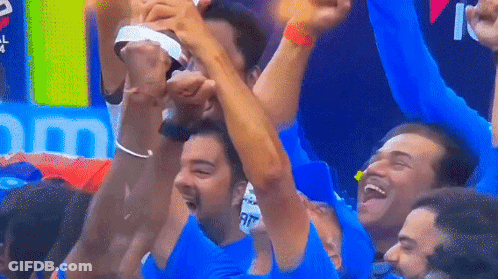 A Group Of Men Are Raising Their Arms In The Air GIF