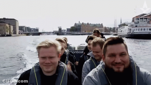 A Group Of Men Are Riding A Boat That Says Pionboa GIF